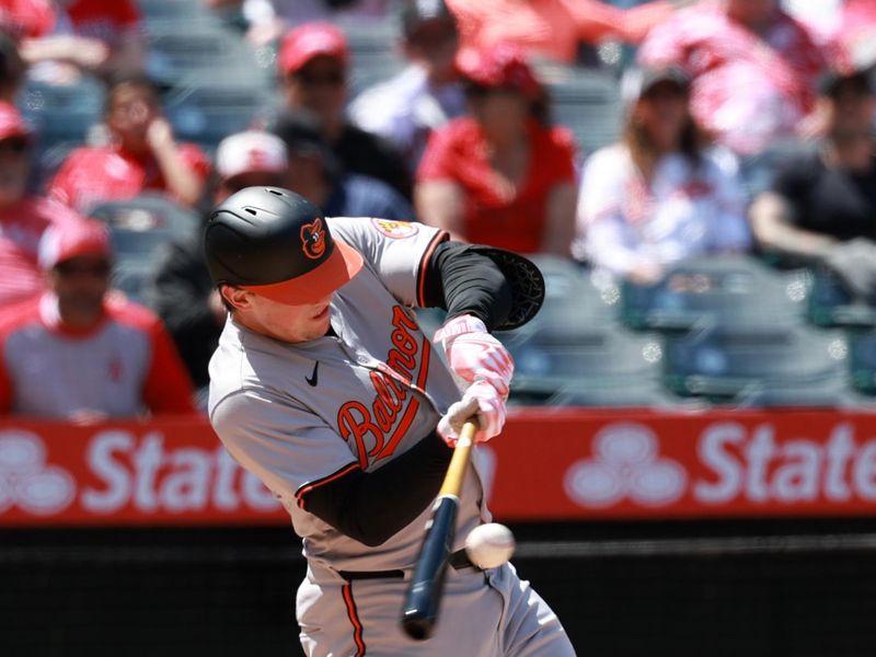 Apr 24, 2024; Anaheim, California, USA;  Baltimore Orioles designated hitter Adley Rutschman (35) hits an RBI single during the fifth inning against the Los Angeles Angels at Angel Stadium. Mandatory Credit: Kiyoshi Mio-USA TODAY Sports