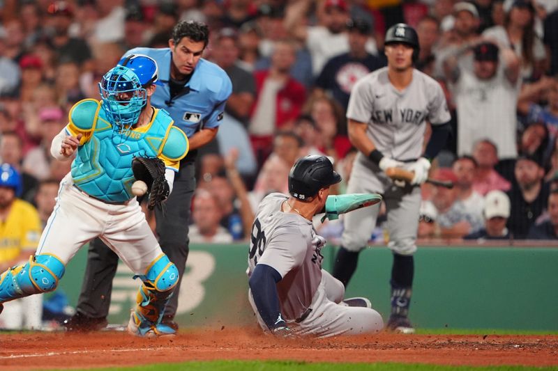 Jul 27, 2024; Boston, Massachusetts, USA; New York Yankees designated hitter Aaron Judge (99) scores a run on New York Yankees third baseman Oswaldo Cabrera (not pictured) sacrifice fly ball against the Boston Red Sox during the seventh inning at Fenway Park. Mandatory Credit: Gregory Fisher-USA TODAY Sports