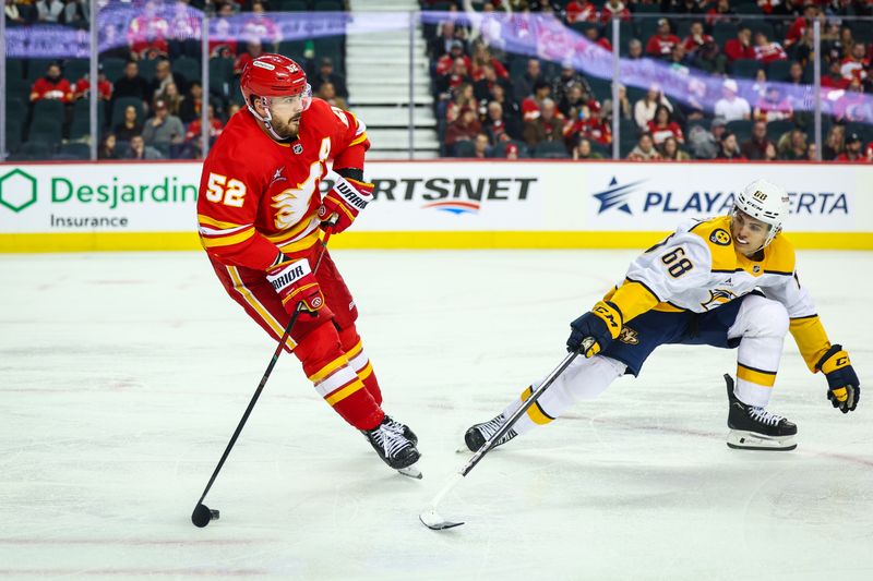 Nov 15, 2024; Calgary, Alberta, CAN; Calgary Flames defenseman MacKenzie Weegar (52) controls the puck against Nashville Predators left wing Zachary L'Heureux (68) during the third period at Scotiabank Saddledome. Mandatory Credit: Sergei Belski-Imagn Images