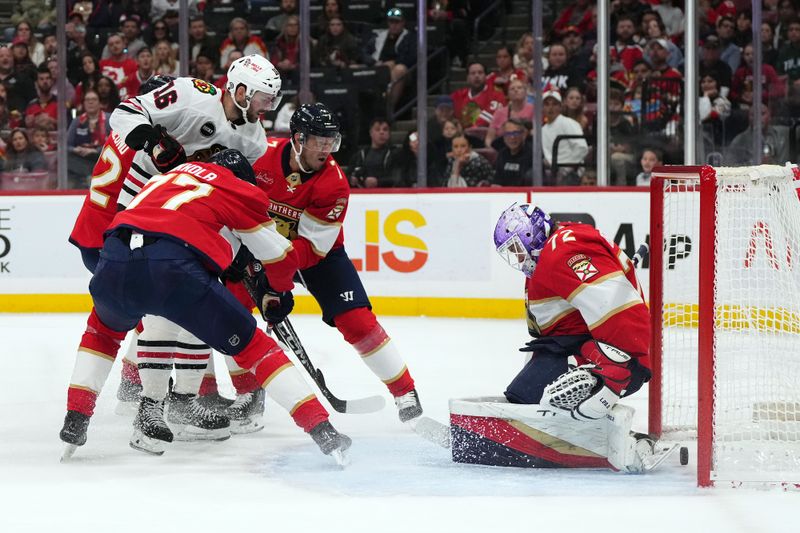 Nov 12, 2023; Sunrise, Florida, USA; Chicago Blackhawks center Jason Dickinson (16) scores a goal on Florida Panthers goaltender Sergei Bobrovsky (72) during the first period at Amerant Bank Arena. Mandatory Credit: Jasen Vinlove-USA TODAY Sports