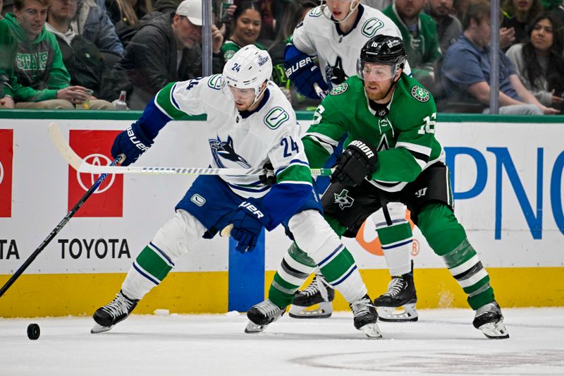 Dec 21, 2023; Dallas, Texas, USA; Vancouver Canucks center Pius Suter (24) and Dallas Stars center Joe Pavelski (16) battle for control of the puck during the third period at the American Airlines Center. Mandatory Credit: Jerome Miron-USA TODAY Sports