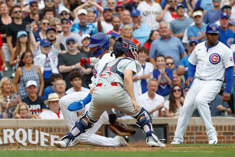 Jul 4, 2024; Chicago, Illinois, USA; Chicago Cubs outfielder Seiya Suzuki (27) scores against the Philadelphia Phillies during the seventh inning at Wrigley Field. Mandatory Credit: Kamil Krzaczynski-USA TODAY Sports