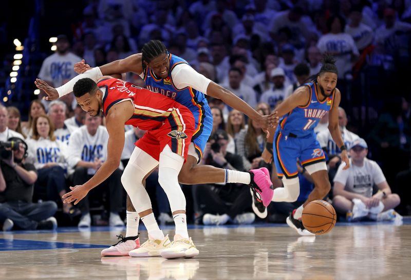 OKLAHOMA CITY, OKLAHOMA - APRIL 24:  Jalen Williams #8 of the Oklahoma City Thunder strips the ball from CJ McCollum #3 of the New Orleans Pelicans during game two of the first round of the NBA playoffs at Paycom Center on April 24, 2024 in Oklahoma City, Oklahoma. (Photo by Jamie Squire/Getty Images)