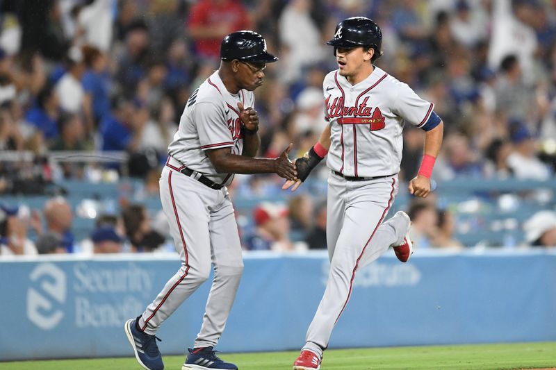 Sep 2, 2023; Los Angeles, California, USA; Atlanta Braves second baseman Nicky Lopez (15) celebrates with third base coach Ron Washington (37) as he scores on home run by shortstop Orlando Arcia (not pictured) against the Los Angeles Dodgers during the 10th inning at Dodger Stadium. Mandatory Credit: Jonathan Hui-USA TODAY Sports