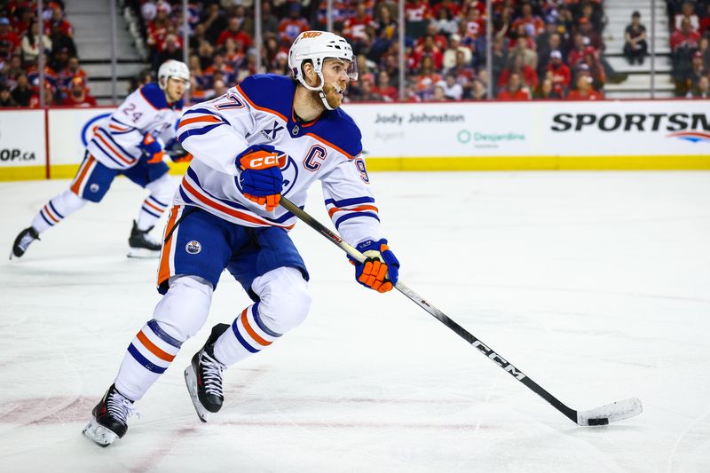 Feb 4, 2026; Calgary, Alberta, CAN; Edmonton Oilers center Connor McDavid (97) skates with the puck against the Calgary Flames during the second period at Scotiabank Saddledome. Mandatory Credit: Sergei Belski-Imagn Images