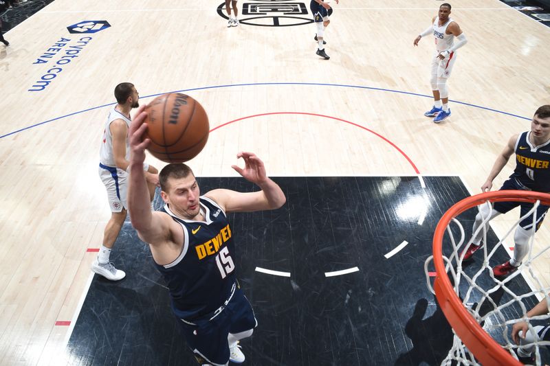 LOS ANGELES, CA - APRIL 4: Nikola Jokic #15 of the Denver Nuggets rebounds the ball during the game against the LA Clippers on April 4, 2024 at Crypto.Com Arena in Los Angeles, California. NOTE TO USER: User expressly acknowledges and agrees that, by downloading and/or using this Photograph, user is consenting to the terms and conditions of the Getty Images License Agreement. Mandatory Copyright Notice: Copyright 2024 NBAE (Photo by Adam Pantozzi/NBAE via Getty Images)