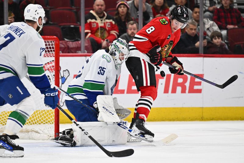 Feb 13, 2024; Chicago, Illinois, USA; Chicago Blackhawks forward Ryan Donato (8) screens Vancouver Canucks goaltender Thatcher Demko (35) on a shot in the third period at United Center. Mandatory Credit: Jamie Sabau-USA TODAY Sports