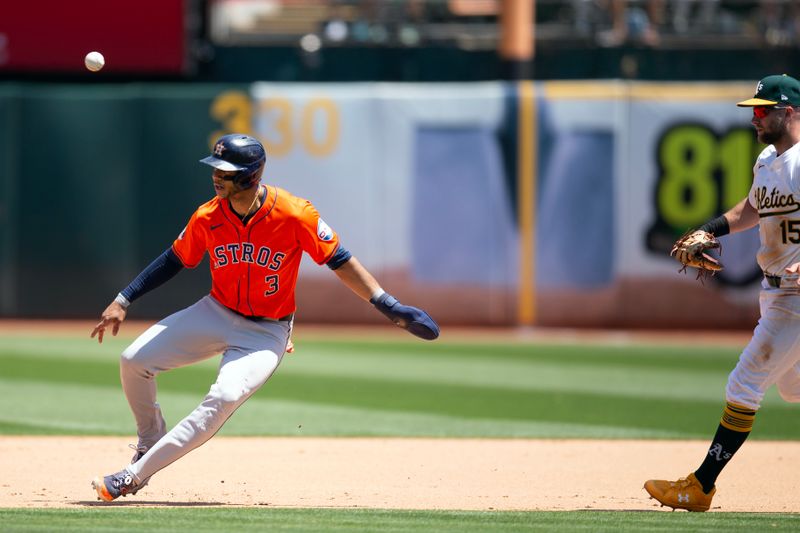 Jul 24, 2024; Oakland, California, USA; Houston Astros shortstop Jeremy Pena (3) is caught in a rundown between first base and second as he is pursued by Oakland Athletics first baseman Seth Brown (15) during the sixth inning at Oakland-Alameda County Coliseum. Mandatory Credit: D. Ross Cameron-USA TODAY Sports