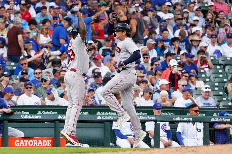 Jul 15, 2023; Chicago, Illinois, USA; Boston Red Sox first baseman Triston Casas (36) is greeted by  third base coach Carlos Febles (53) after hitting a two-run home run against the Chicago Cubs during the seventh inning at Wrigley Field. Mandatory Credit: David Banks-USA TODAY Sports