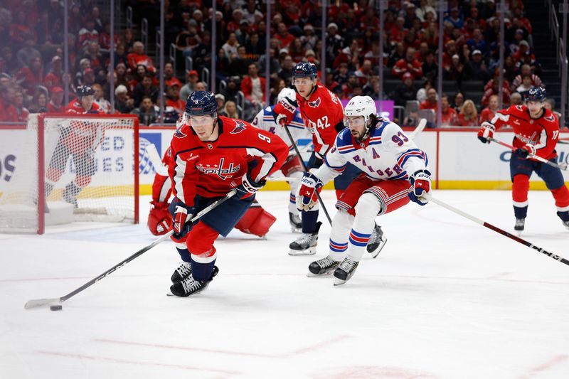 Dec 23, 2025; Washington, District of Columbia, USA; Washington Capitals right wing Ryan Leonard (9) skates with the puck as New York Rangers center Mika Zibanejad (93) chases during the second period at Capital One Arena. Mandatory Credit: Geoff Burke-Imagn Images