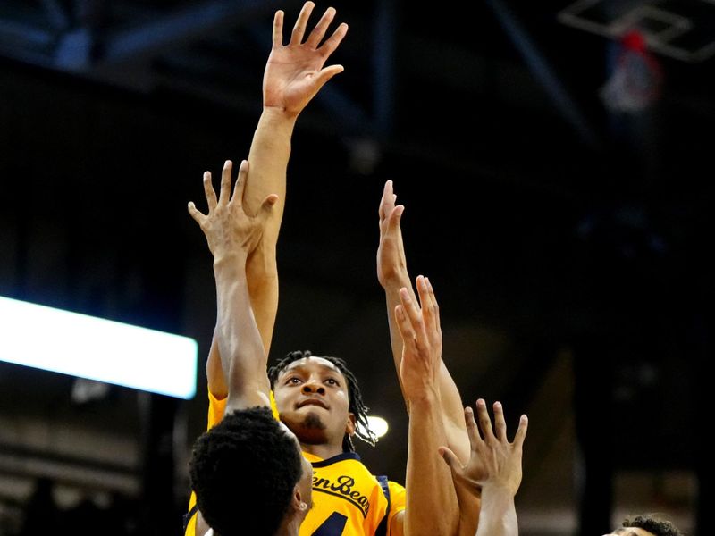 Feb 2, 2023; Boulder, Colorado, USA; California Golden Bears forward Sam Alajiki (24) shoots over Colorado Buffaloes guard Jalen Gabbidon (3) and guard Nique Clifford (32) in the second half at the CU Events Center. Mandatory Credit: Ron Chenoy-USA TODAY Sports