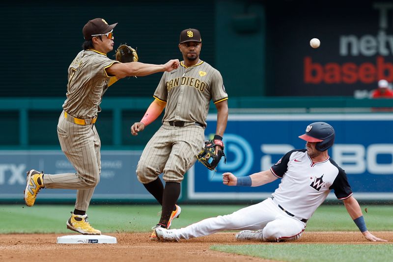 Jul 25, 2024; Washington, District of Columbia, USA; San Diego Padres shortstop Ha-Seong Kim (7) turns a double play at second base ahead of a slide by Washington Nationals outfielder Lane Thomas (28) during the fourth inning at Nationals Park. Mandatory Credit: Geoff Burke-USA TODAY Sports