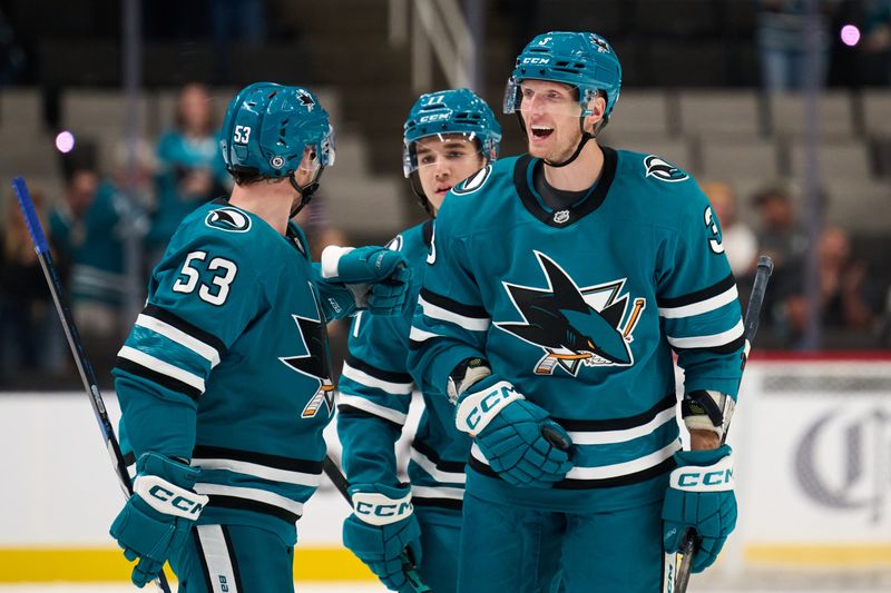 Sep 21, 2025; San Jose, California, USA; San Jose Sharks defenseman John Klingberg (3) celebrates with left wing Jeff Skinner (53) and forward Michael Misa (77) after scoring a power play goal against the Vegas Golden Knights during the second period at SAP Center at San Jose. Mandatory Credit: Robert Edwards-Imagn Images