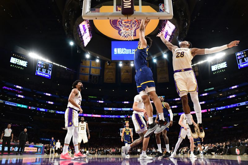 LOS ANGELES, CA - MACH 16: Trayce Jackson-Davis #32 of the Golden State Warriors  drives to the basket during the game against the Los Angeles Lakers on March 16, 2024 at Crypto.Com Arena in Los Angeles, California. NOTE TO USER: User expressly acknowledges and agrees that, by downloading and/or using this Photograph, user is consenting to the terms and conditions of the Getty Images License Agreement. Mandatory Copyright Notice: Copyright 2024 NBAE (Photo by Adam Pantozzi/NBAE via Getty Images)