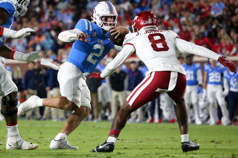 Oct 7, 2023; Oxford, Mississippi, USA; Mississippi Rebels quarterback Jaxson Dart (2) runs with the ball as Arkansas Razorbacks defensive back Jayden Johnson (8) attempts to make the tackle during the first quarter at Vaught-Hemingway Stadium. Mandatory Credit: Petre Thomas-USA TODAY Sports