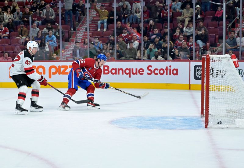 Sep 24, 2024; Montreal, Quebec, CAN; Montreal Canadiens forward Michael Pezzetta (55) beats New Jersey Devils forward Curtis Lazar (42) to the puck to score an empty net goal during the third period at the Bell Centre. Mandatory Credit: Eric Bolte-Imagn Images