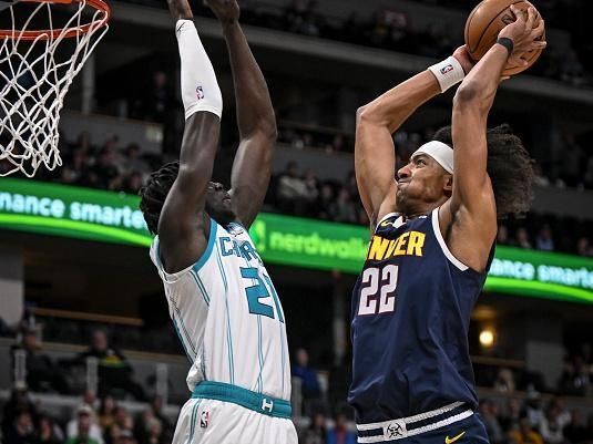 DENVER, CO - JANUARY 1: Zeke Nnaji (22) of the Denver Nuggets goes up for a dunk against JT Thor (21) of the Charlotte Hornets during the fourth quarter of the Nuggets' 111-93 win at Ball Arena in Denver on Monday, January 1, 2024. (Photo by AAron Ontiveroz/The Denver Post)