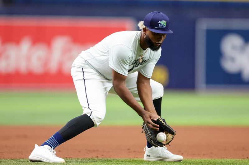 Aug 13, 2024; St. Petersburg, Florida, USA; Tampa Bay Rays third baseman Junior Caminero (13) takes fielding practice before a game against the Houston Astros at Tropicana Field. Mandatory Credit: Nathan Ray Seebeck-USA TODAY Sports