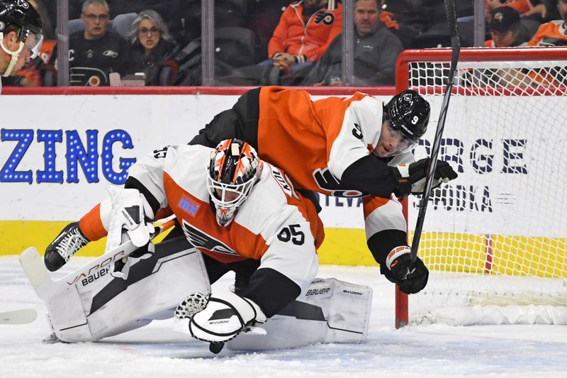 Oct 27, 2024; Philadelphia, Pennsylvania, USA; Philadelphia Flyers goaltender Aleksei Kosolov (35) makes a save with help from defenseman Jamie Drysdale (9) against the Montreal Canadiens during the first period at Wells Fargo Center. Mandatory Credit: Eric Hartline-Imagn Images