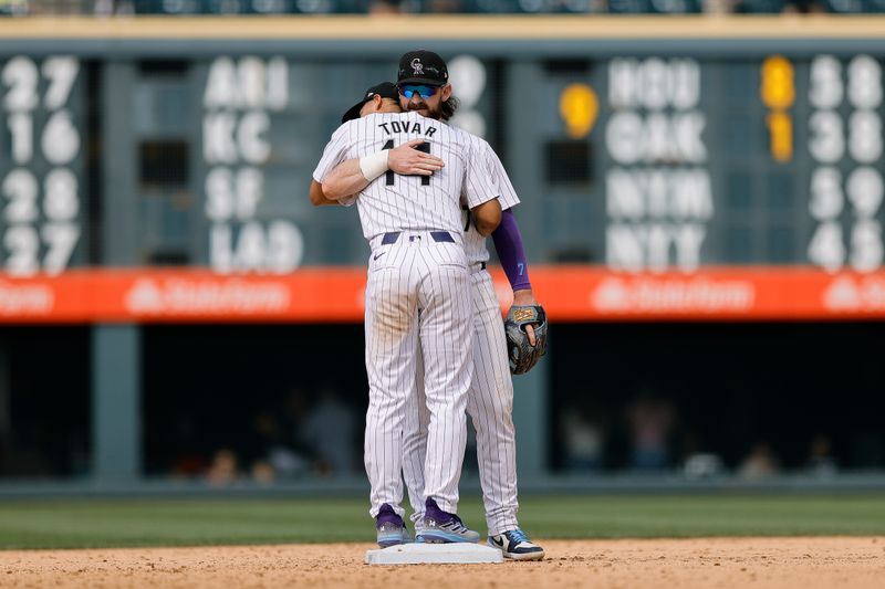 Jul 24, 2024; Denver, Colorado, USA; Colorado Rockies shortstop Ezequiel Tovar (14) reacts with second baseman Brendan Rodgers (7) after the game against the Boston Red Sox at Coors Field. Mandatory Credit: Isaiah J. Downing-USA TODAY Sports