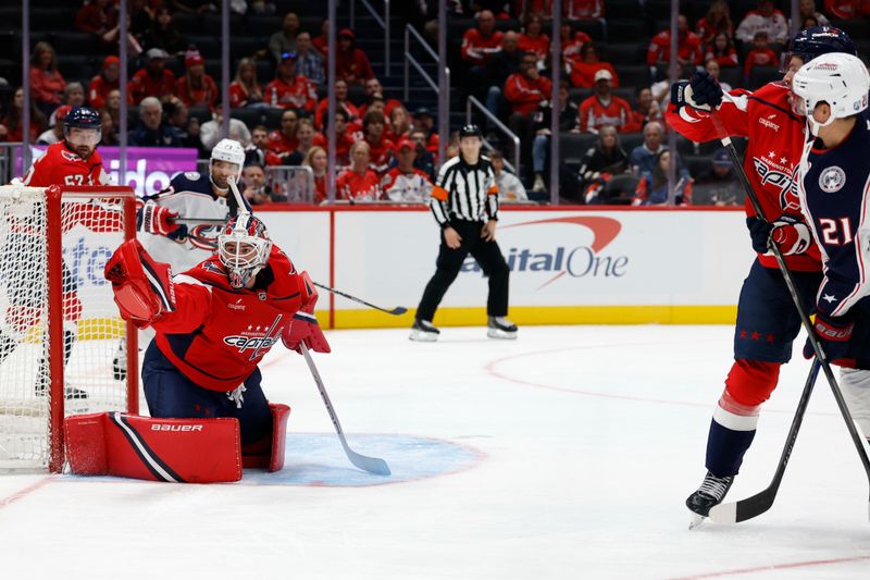 Oct 4, 2025; Washington, District of Columbia, USA; Washington Capitals goaltender Logan Thompson (48) makes a save in front of Columbus Blue Jackets center Isac Lundestrom (21) in the second period at Capital One Arena. Mandatory Credit: Geoff Burke-Imagn Images