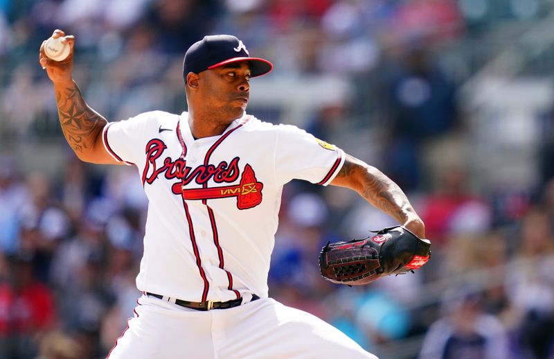 Sep 10, 2023; Cumberland, Georgia, USA; Atlanta Braves relief pitcher Raisel Iglesias (26) pitching against the Pittsburgh Pirates during the ninth inning at Truist Park. Mandatory Credit: John David Mercer-USA TODAY Sports