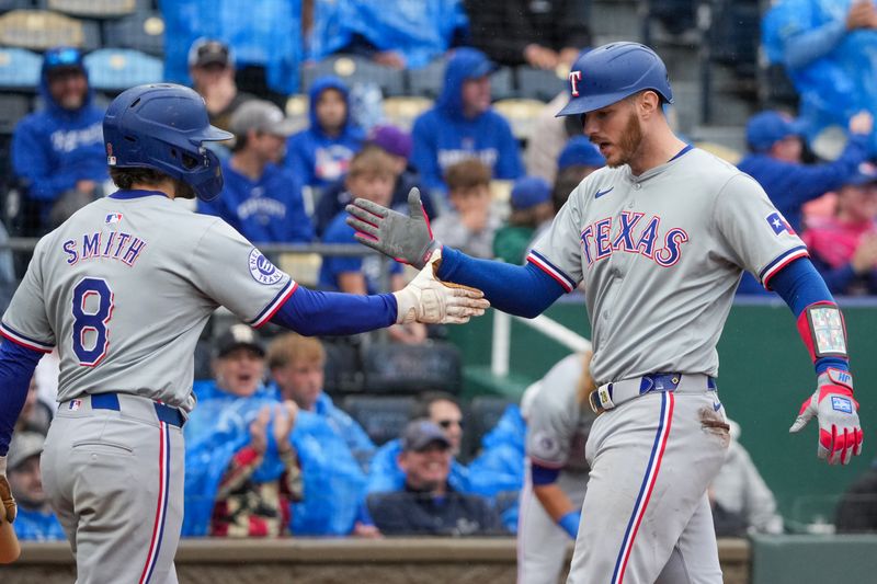 May 5, 2024; Kansas City, Missouri, USA; Texas Rangers catcher Jonah Heim (28) celebrates with shortstop Josh Smith (8) after hitting a game-tying solo home run against the Kansas City Royals in the ninth inning at Kauffman Stadium. Mandatory Credit: Denny Medley-USA TODAY Sports