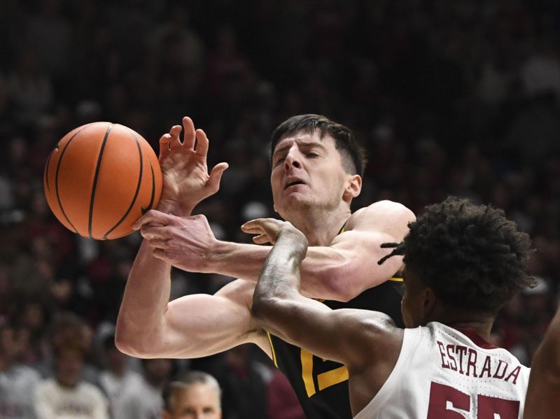 Jan 16, 2024; Tuscaloosa, Alabama, USA; Alabama guard Aaron Estrada contacts Missouri forward Jesus Carralero Martin (13), causing him to lose possession of the ball in their game at Coleman Coliseum. Mandatory Credit: Gary Cosby Jr.-USA TODAY Sports