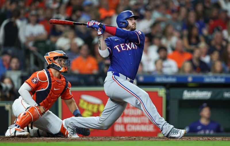 Apr 12, 2024; Houston, Texas, USA; Texas Rangers catcher Jonah Heim (28) hits a home run during the third inning against the Houston Astros at Minute Maid Park. Mandatory Credit: Troy Taormina-USA TODAY Sports
