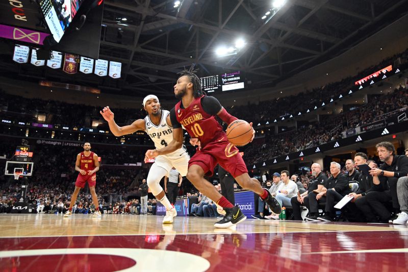 CLEVELAND, OHIO - FEBRUARY 13: Darius Garland #10 of the Cleveland Cavaliers drives around Blake Wesley #14 of the San Antonio Spurs during the fourth quarter at Rocket Mortgage Fieldhouse on February 13, 2023 in Cleveland, Ohio. The Cavaliers defeated the Spurs 117-109. NOTE TO USER: User expressly acknowledges and agrees that, by downloading and or using this photograph, User is consenting to the terms and conditions of the Getty Images License Agreement. (Photo by Jason Miller/Getty Images)