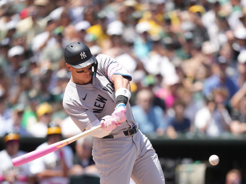 May 11, 2025; West Sacramento, California, USA; New York Yankees right fielder Aaron Judge (99) hits an RBI single against the Athletics in the second inning at Sutter Health Park. Mandatory Credit: Cary Edmondson-Imagn Images