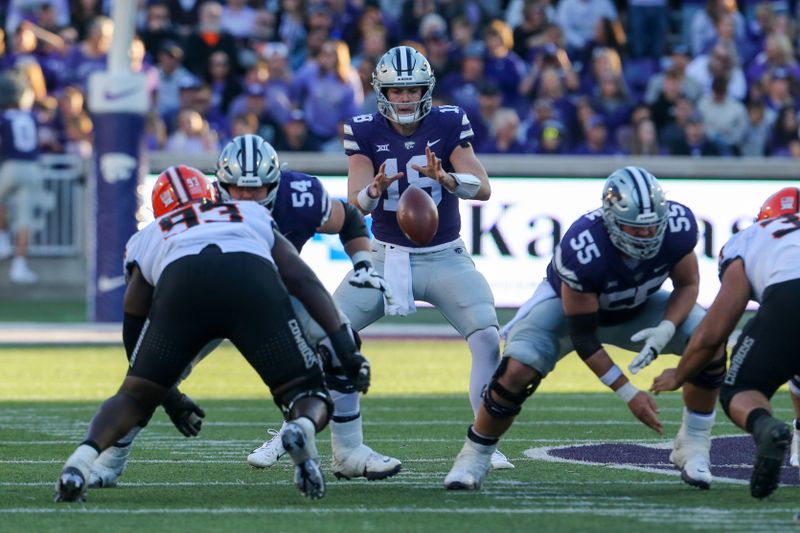 Oct 29, 2022; Manhattan, Kansas, USA; Kansas State Wildcats quarterback Will Howard (18) takes the snap from center Hayden Gillum (55) against the Oklahoma State Cowboys during the fourth quarter at Bill Snyder Family Football Stadium. Mandatory Credit: Scott Sewell-USA TODAY Sports
