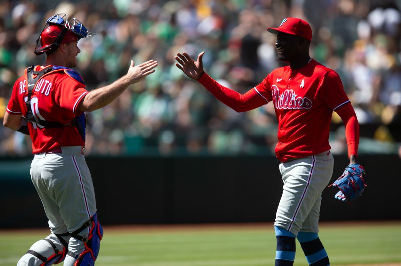 Jun 18, 2023; Oakland, California, USA; Philadelphia Phillies catcher J.T. Realmuto (10) and pitcher Yunior Marte celebrate their 3-2 victory over the Oakland Athletics at Oakland-Alameda County Coliseum. Mandatory Credit: D. Ross Cameron-USA TODAY Sports