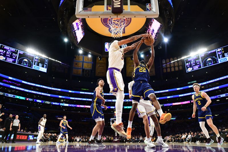 LOS ANGELES, CA - MACH 16: Anthony Davis #3 of the Los Angeles Lakers blocls Andrew Wiggins #22 of the Golden State Warriors during the game on March 16, 2024 at Crypto.Com Arena in Los Angeles, California. NOTE TO USER: User expressly acknowledges and agrees that, by downloading and/or using this Photograph, user is consenting to the terms and conditions of the Getty Images License Agreement. Mandatory Copyright Notice: Copyright 2024 NBAE (Photo by Adam Pantozzi/NBAE via Getty Images)