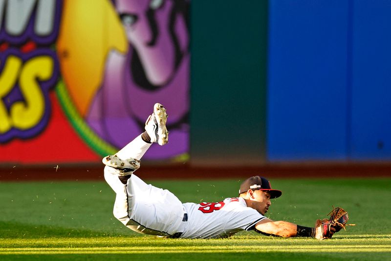 Oct 7, 2024; Cleveland, Ohio, USA; Cleveland Guardians outfielder Steven Kwan (38) dives to make a catch during the eighth inning against the Detroit Tigers during game two of the ALDS for the 2024 MLB Playoffs at Progressive Field. Mandatory Credit: Scott Glavin-Imagn Images