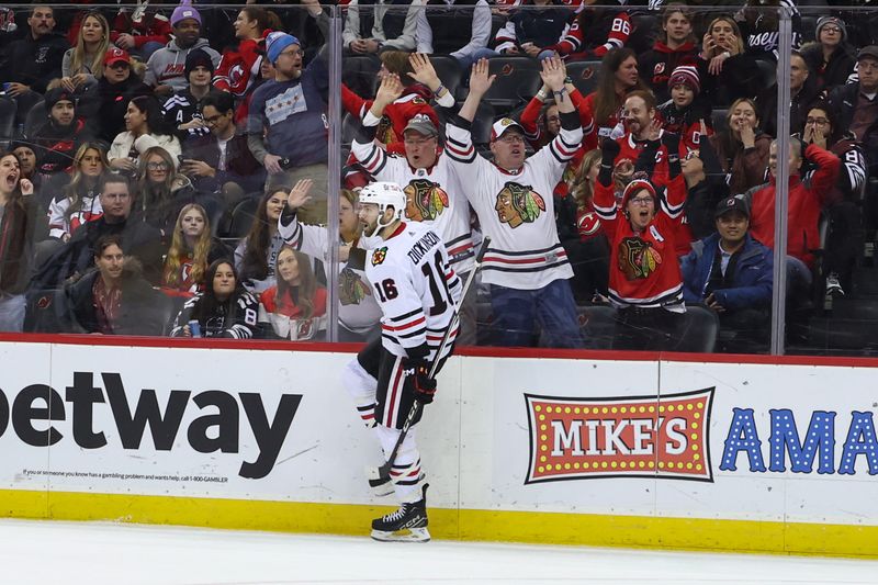 Jan 5, 2024; Newark, New Jersey, USA; Chicago Blackhawks center Jason Dickinson (16) celebrates his goal against the New Jersey Devils during the first period at Prudential Center. Mandatory Credit: Ed Mulholland-USA TODAY Sports