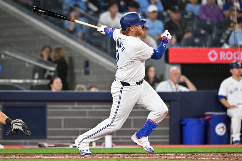 Apr 10, 2024; Toronto, Ontario, CAN;   Toronto Blue Jays first baseman Justin Turner (2) hits a single against the Seattle Mariners in the ninth inning at Rogers Centre. Mandatory Credit: Dan Hamilton-USA TODAY Sports