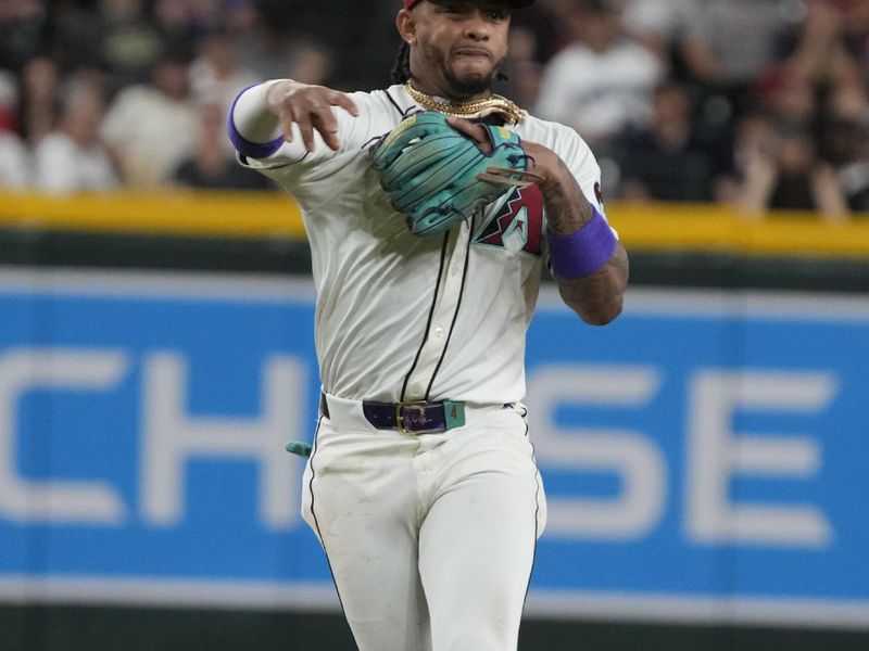 May 24, 2024; Phoenix, Arizona, USA; Arizona Diamondbacks second base Ketel Marte (4) makes the off balance throw for an out against the Miami Marlins in the eighth inning at Chase Field. Mandatory Credit: Rick Scuteri-USA TODAY Sports