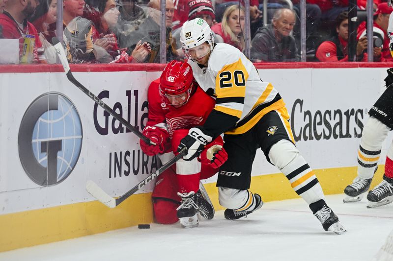 Oct 10, 2024; Detroit, Michigan, USA; Pittsburgh Penguins center Lars Eller (20) and Detroit Red Wings right wing Jonatan Berggren (48) battle for the puck during the second period at Little Caesars Arena. Mandatory Credit: Tim Fuller-Imagn Images