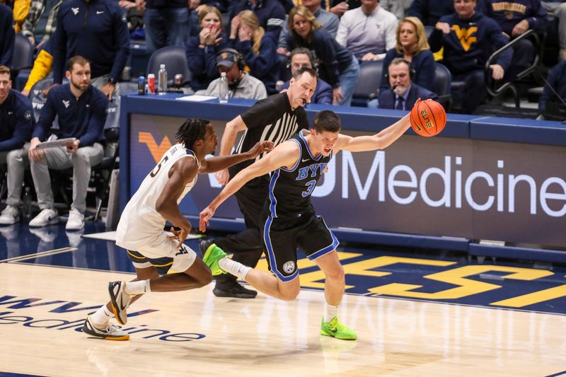 Feb 11, 2025; Morgantown, West Virginia, USA; Brigham Young Cougars guard Egor Demin (3) is fouled by West Virginia Mountaineers guard Toby Okani (5) during the second half at WVU Coliseum. Mandatory Credit: Ben Queen-Imagn Images