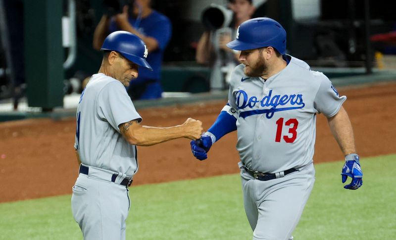 Jul 23, 2023; Arlington, Texas, USA;  Los Angeles Dodgers third baseman Max Muncy (13) celebrates with Los Angeles Dodgers third base coach Dino Ebel (91) after hitting a grand slam during the first inning against the Texas Rangers at Globe Life Field. Mandatory Credit: Kevin Jairaj-USA TODAY Sports