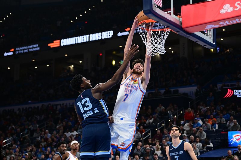 OKLAHOMA CITY, OKLAHOMA - DECEMBER 18: Chet Holmgren #7 of the Oklahoma City Thunder goes up for a dunk while being defended by Jaren Jackson Jr. #13 of the Memphis Grizzlies during the second half at Paycom Center on December 18, 2023 in Oklahoma City, Oklahoma. NOTE TO USER: User expressly acknowledges and agrees that, by downloading and or using this Photograph, user is consenting to the terms and conditions of the Getty Images License Agreement. (Photo by Joshua Gateley/Getty Images)