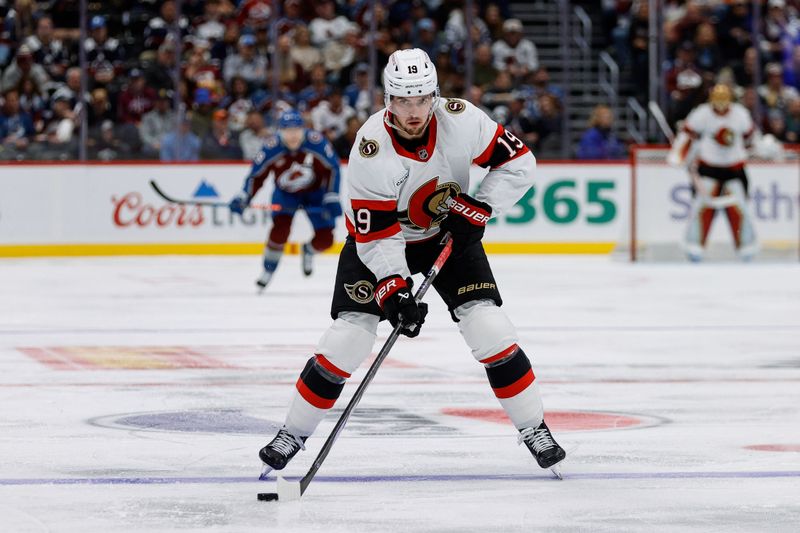 Oct 27, 2024; Denver, Colorado, USA; Ottawa Senators right wing Drake Batherson (19) controls the puck in the third period against the Colorado Avalanche at Ball Arena. Mandatory Credit: Isaiah J. Downing-Imagn Images