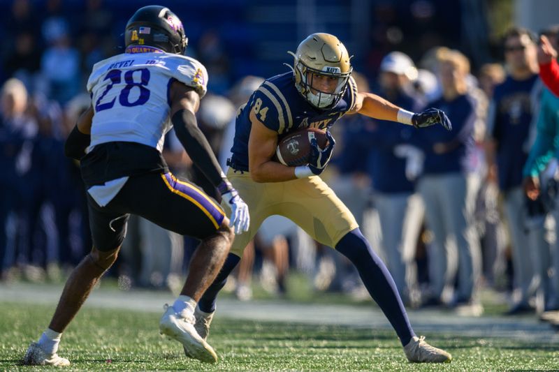 Nov 18, 2023; Annapolis, Maryland, USA; Navy Midshipmen wide receiver Regis Velez (84) runs the ball against East Carolina Pirates defensive back Shavon Revel (28) during the second quarter at Navy-Marine Corps Memorial Stadium. Mandatory Credit: Reggie Hildred-USA TODAY Sports