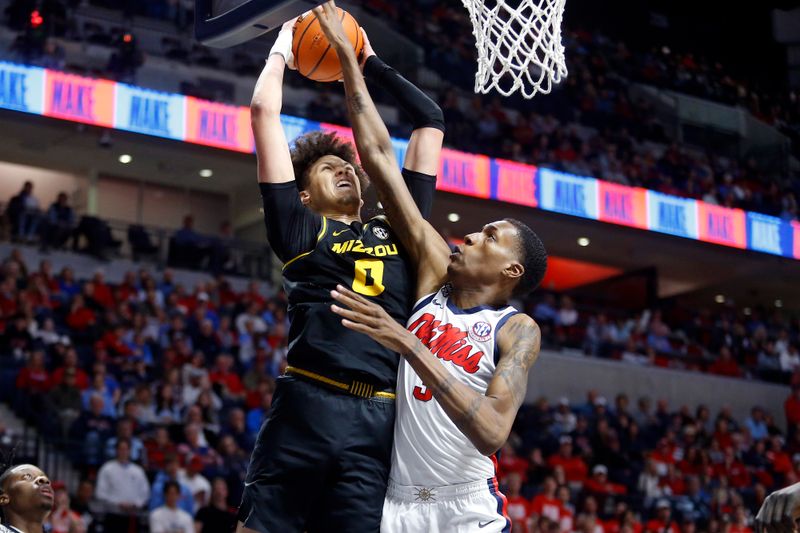 Feb 17, 2024; Oxford, Mississippi, USA; Missouri Tigers forward Jordan Butler (0) drives to the basket as Mississippi Rebels forward Jamarion Sharp (3) defends during the first half at The Sandy and John Black Pavilion at Ole Miss. Mandatory Credit: Petre Thomas-USA TODAY Sports