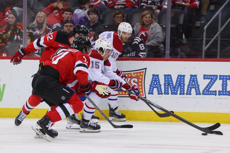 Nov 7, 2024; Newark, New Jersey, USA; Montreal Canadiens center Alex Newhook (15) skates with the puck against New Jersey Devils defenseman Jonas Siegenthaler (71) during the first period at Prudential Center. Mandatory Credit: Ed Mulholland-Imagn Images