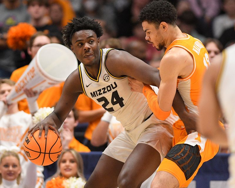 Mar 10, 2023; Nashville, TN, USA;  Missouri Tigers guard Kobe Brown (24) backs down Tennessee Volunteers forward Olivier Nkamhoua (13) during the first half at Bridgestone Arena. Mandatory Credit: Steve Roberts-USA TODAY Sports