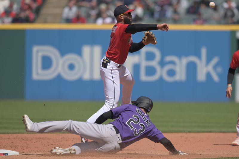 Apr 26, 2023; Cleveland, Ohio, USA; Cleveland Guardians shortstop Amed Rosario (1) forces out Colorado Rockies right fielder Kris Bryant (23) and completes the double play during the sixth inning at Progressive Field. Mandatory Credit: Ken Blaze-USA TODAY Sports