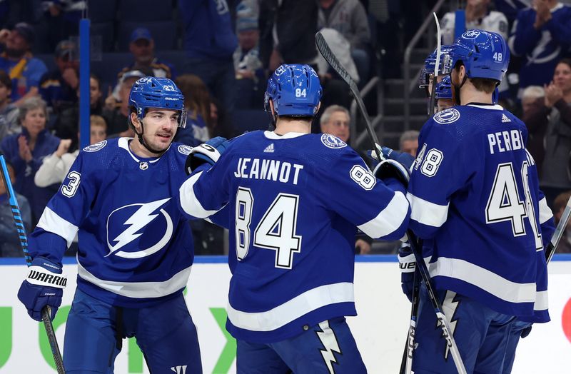 Dec 19, 2023; Tampa, Florida, USA; Tampa Bay Lightning center Michael Eyssimont (23) is congratulated after scoring against the St. Louis Blues during the first period at Amalie Arena. Mandatory Credit: Kim Klement Neitzel-USA TODAY Sports