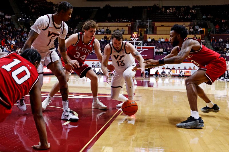 Jan 15, 2025; Blacksburg, Virginia, USA; Virginia Tech Hokies forward Ben Burnham (13) goes for a loose ball against North Carolina State Wolfpack forward Ben Middlebrooks (34) and guard Dontrez Styles (3) during the second half at Cassell Coliseum. Mandatory Credit: Peter Casey-Imagn Images